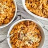 Greek lamb and tomato stew in a white bowl with orzo pasta- Kritharaki- Yiouvetsi