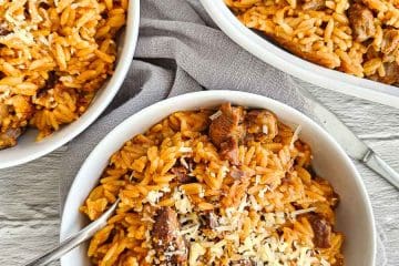 Greek lamb and tomato stew in a white bowl with orzo pasta- Kritharaki- Yiouvetsi