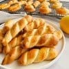 Greek Easter cookies-koulourakia on white plate and cooling rack.