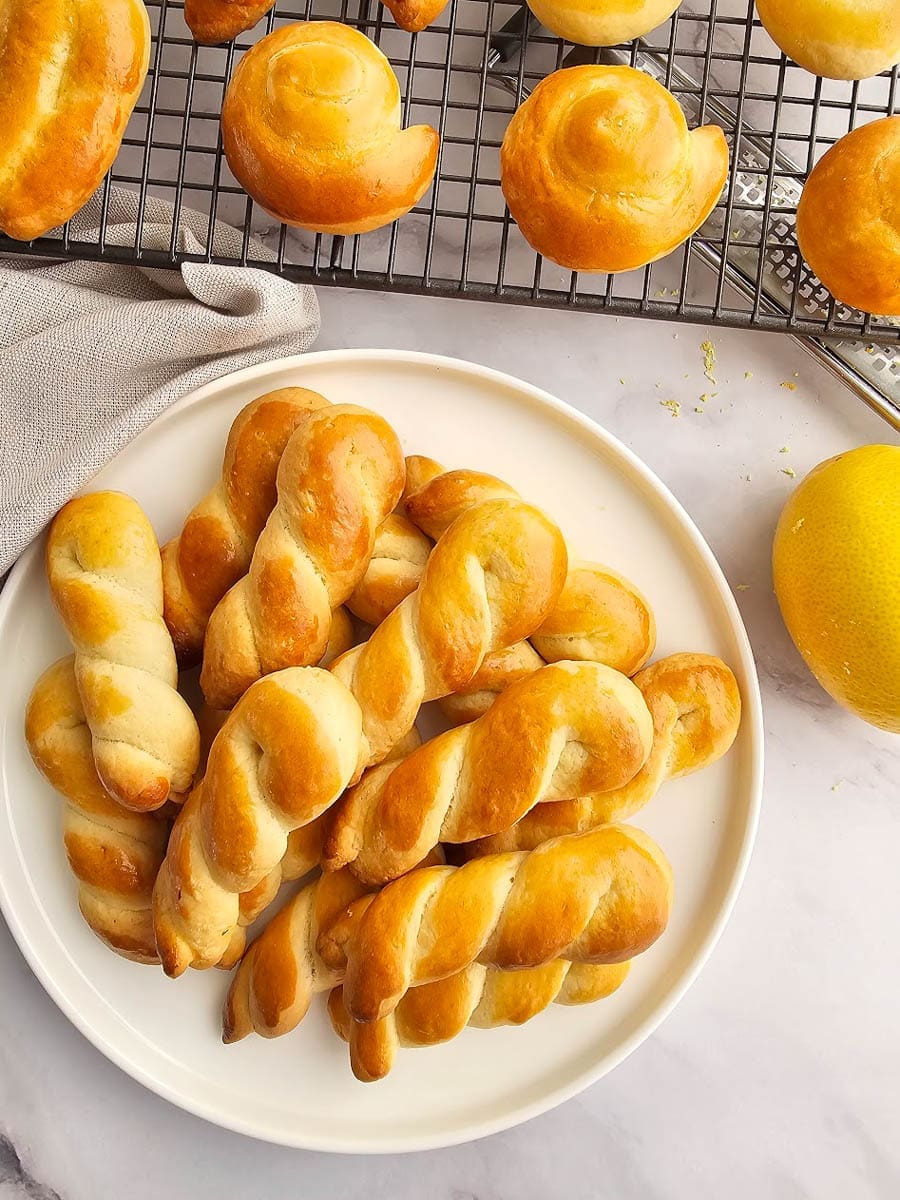 Greek Easter cookies-koulourakia on plate with lemon zest.