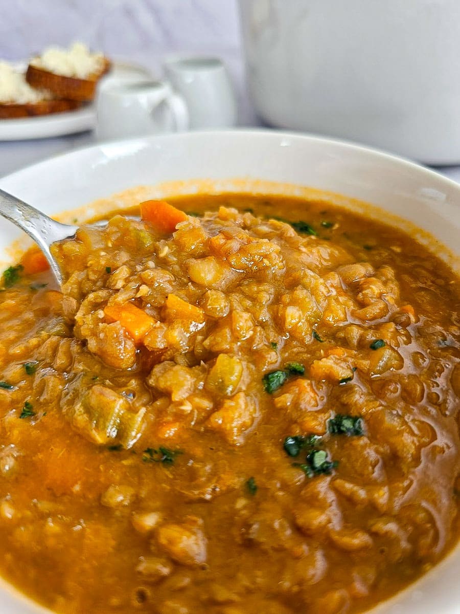 Greek lentil soup, fakes in bowl with spoon. 