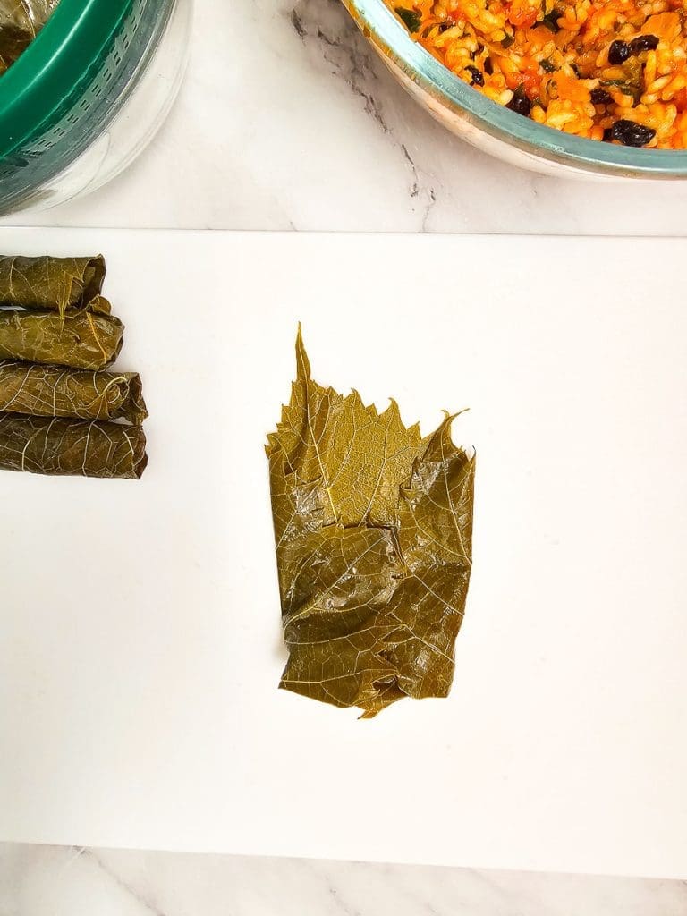 steps to fill and roll vine leaves.