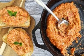 strapadsada-scrambled eggs and tomatoes in pan and on sliced bread on board