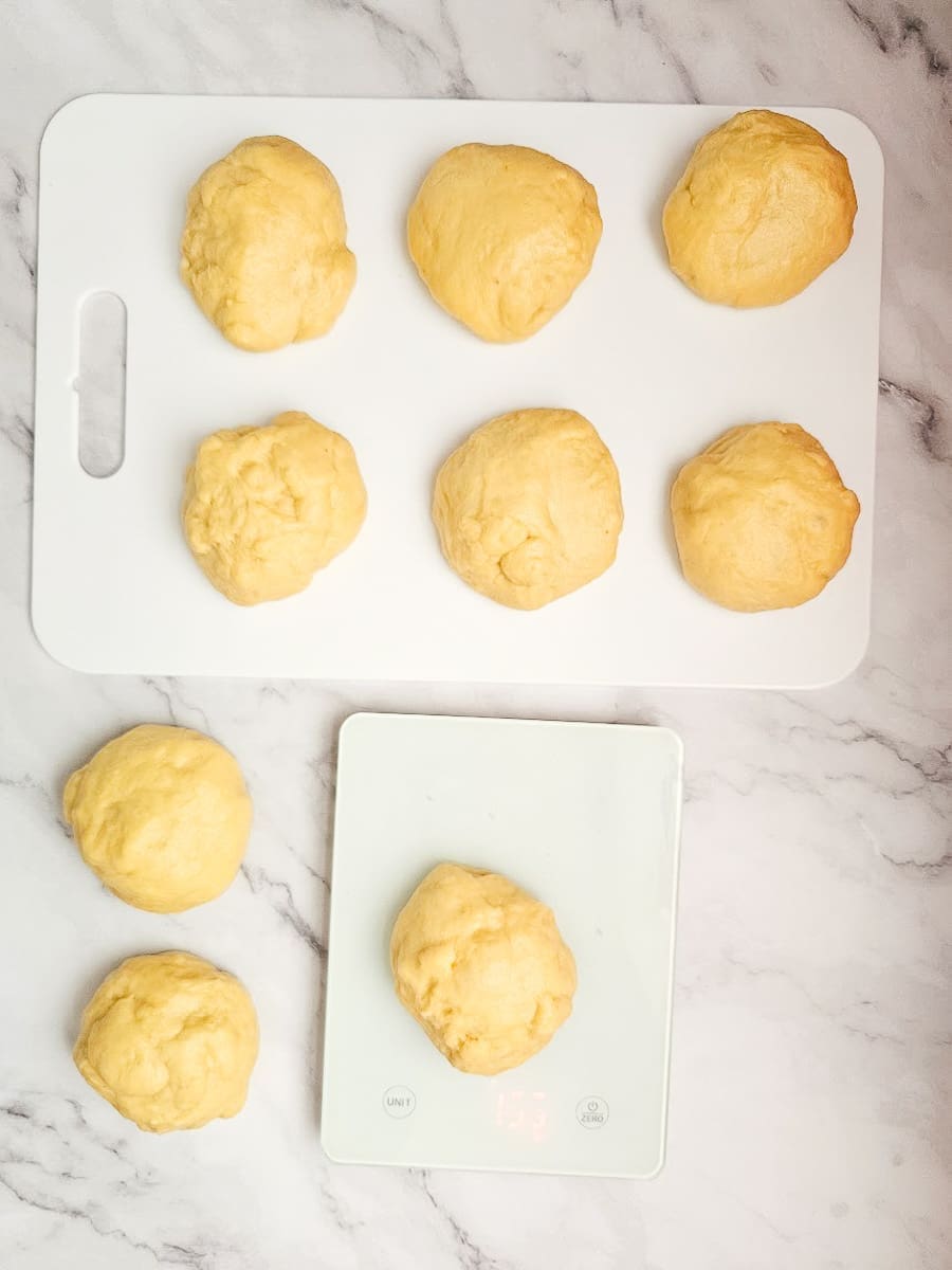 tsoureki dough-balls on board and digital scales.