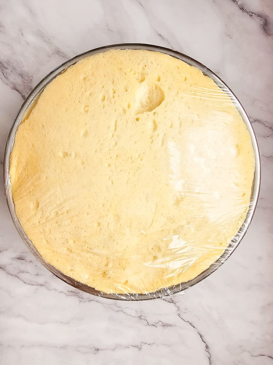 tsoureki dough doubled in size in bowl.