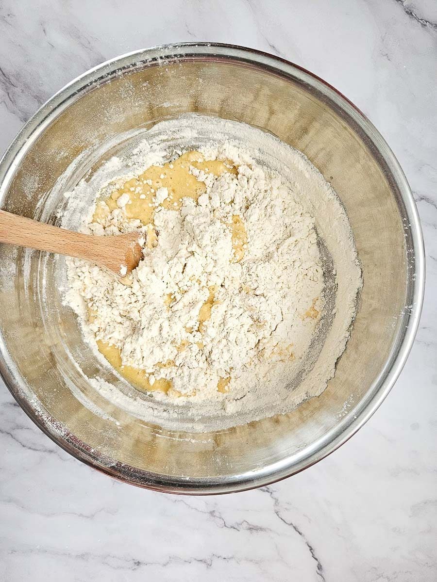 tsoureki- adding flour to yeast mixture.