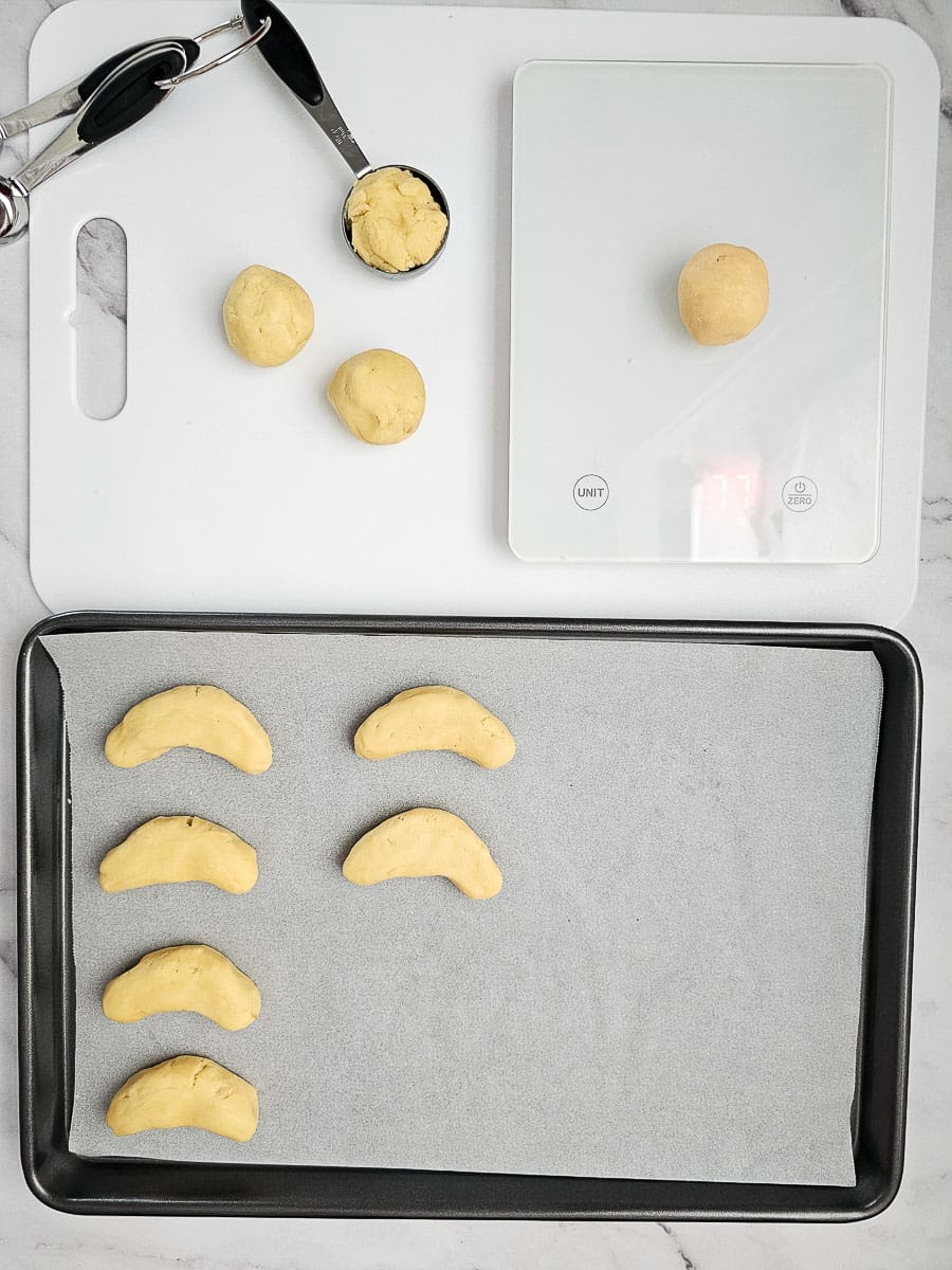 Greek Almond Shortbread Cookies-Kourambiedes-on baking tray before baking- and on scales