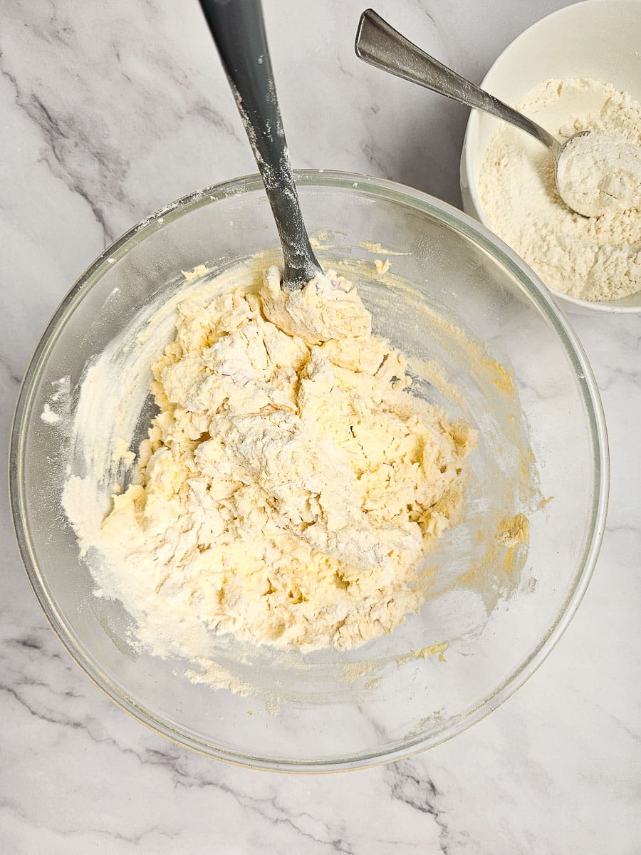 adding flour to cookie dough