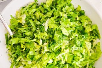 Greek lettuce salad maroulosalata in a white bowl