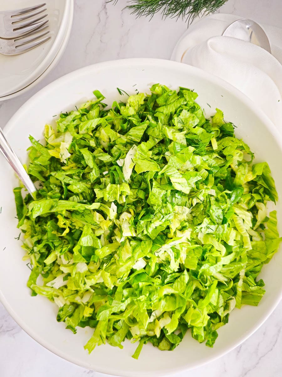 Greek lettuce salad maroulosalata in a white bowl