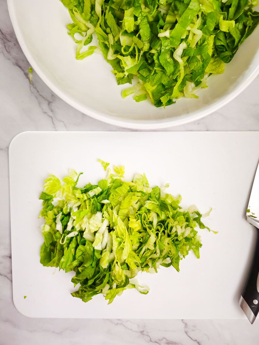 cos / romaine lettuce on a chopping board shredded