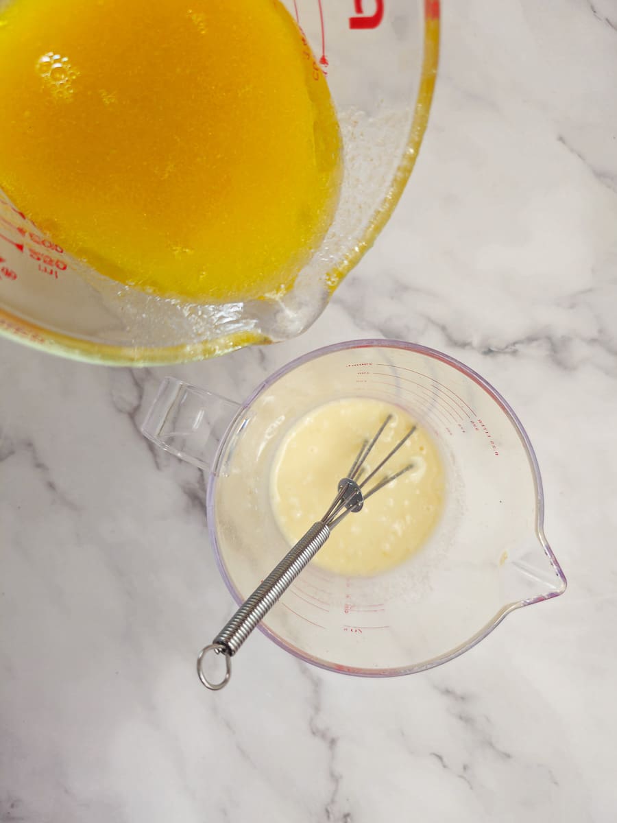 adding broth to flour water paste