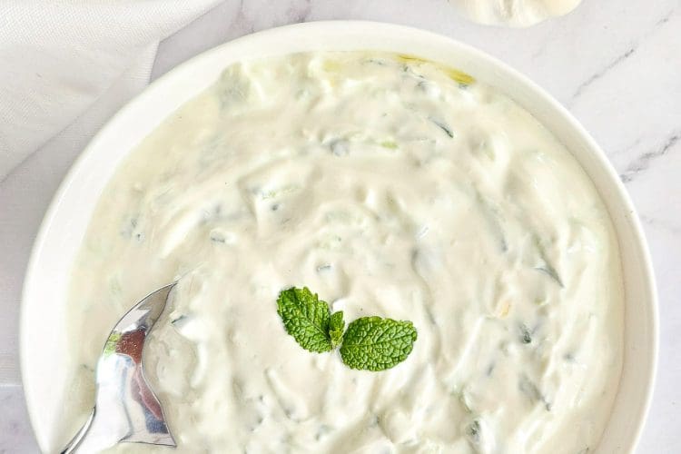 Tzatziki in white bowl with a spoon