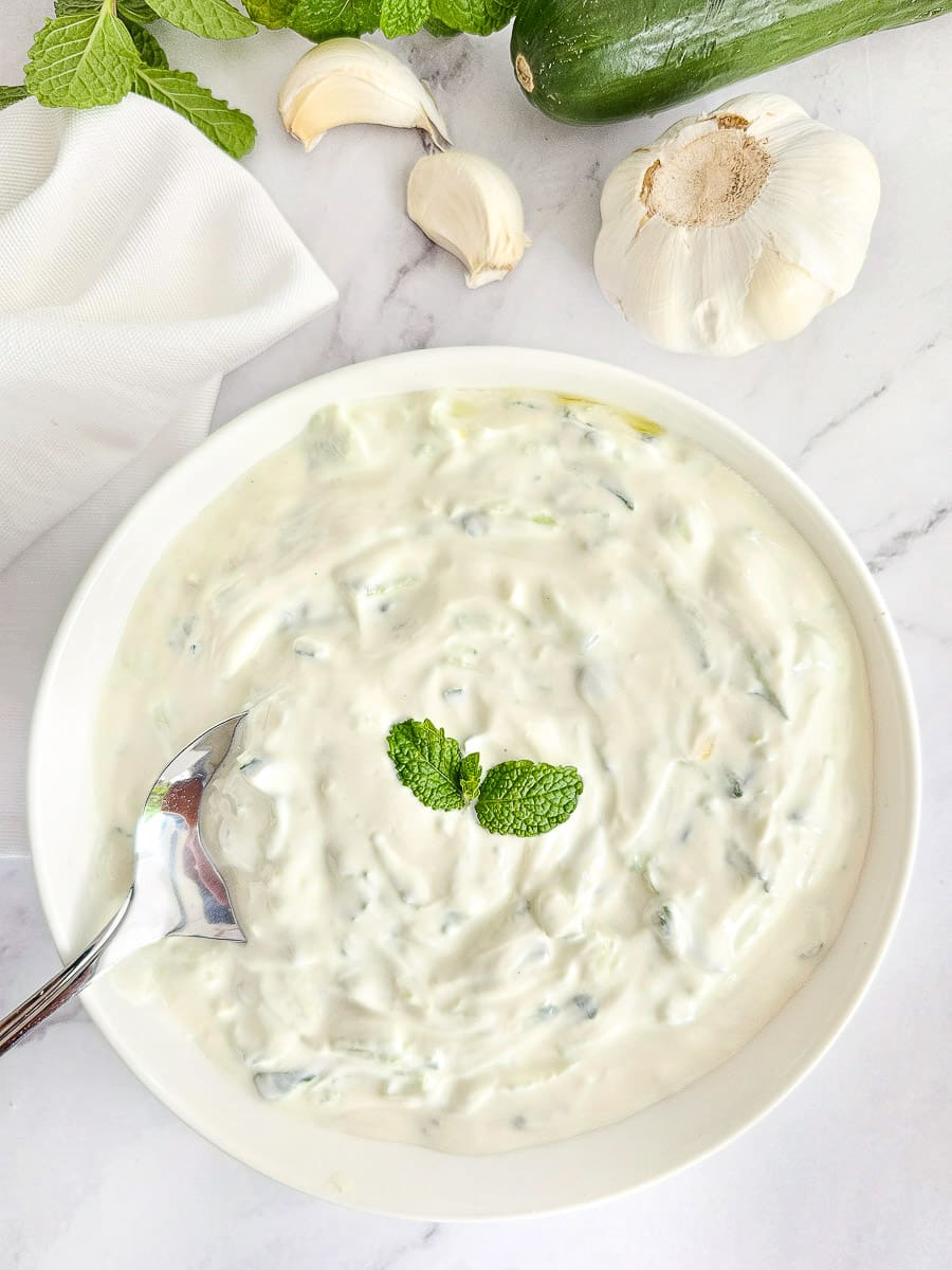 Tzatziki in white bowl with a spoon