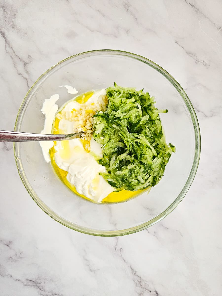 Tzatziki- combining ingredients in a bowl