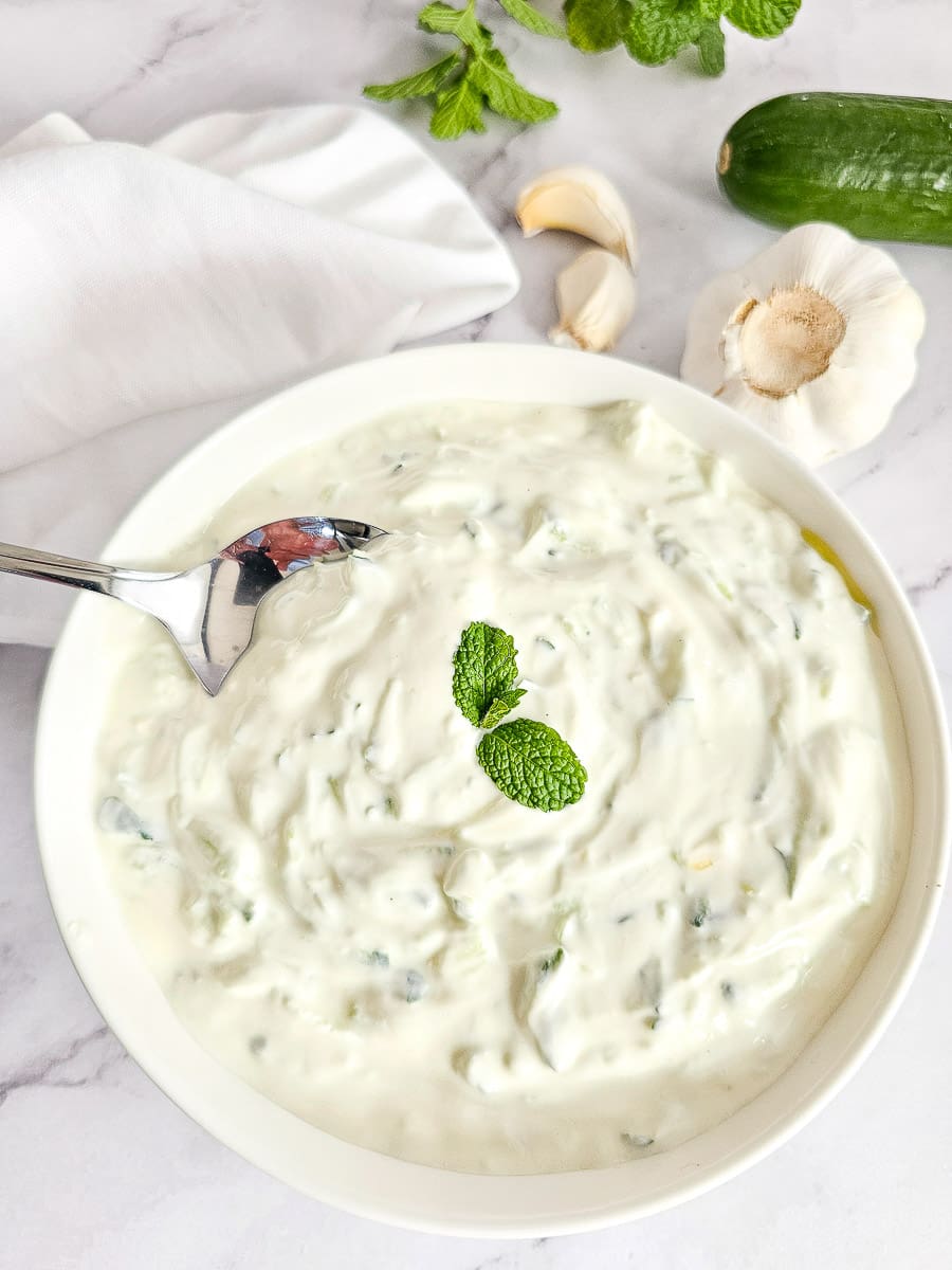 Tzatziki in a bowl ready to serve with a spoon.