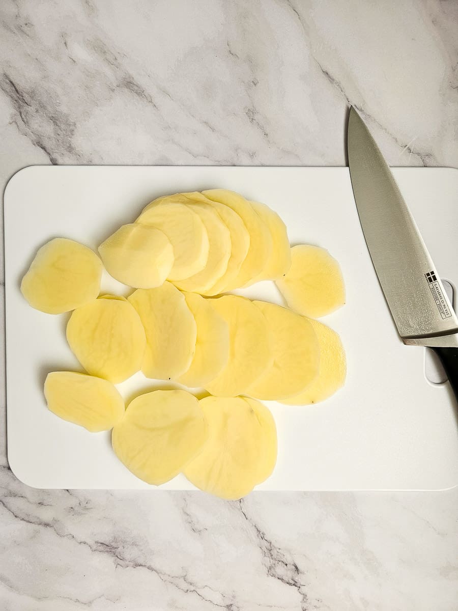 sliced potatoes on a chopping board