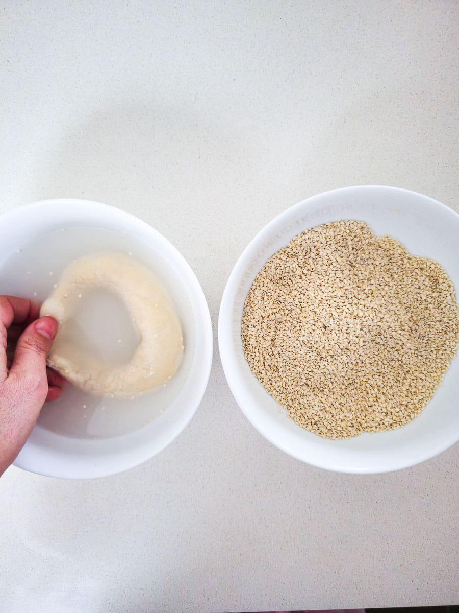 Greek Sesame Bread Rings - Koulouri Thessaloniki - dipping in water and sesame seeds