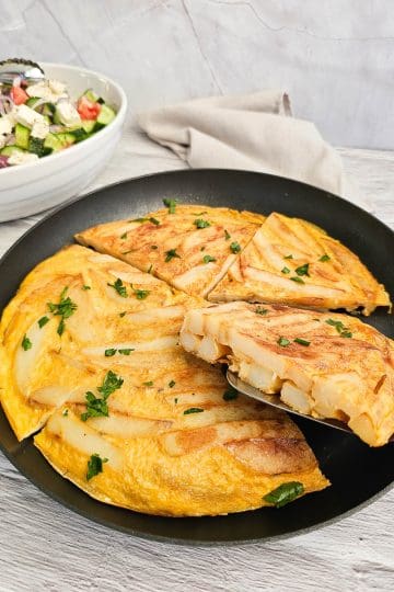 Greek Style Potato Omelette in a frying pan