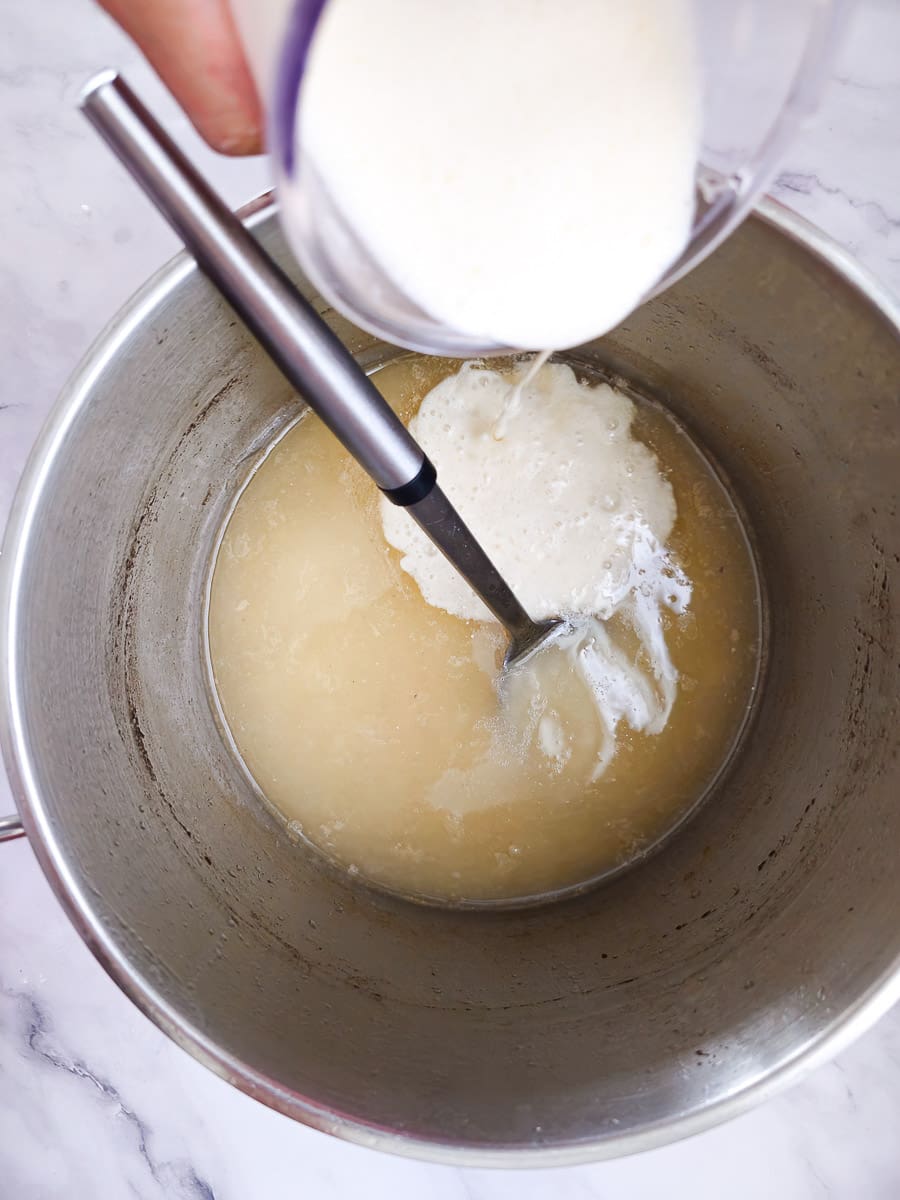 adding avgolemono to pot of Greek lemon chicken soup