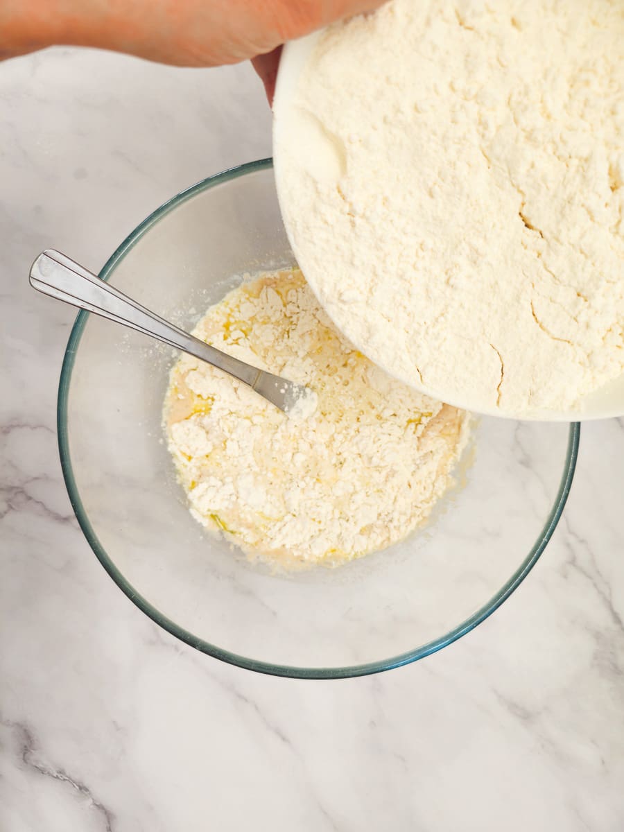 Adding flour to yeast mixture to make dough