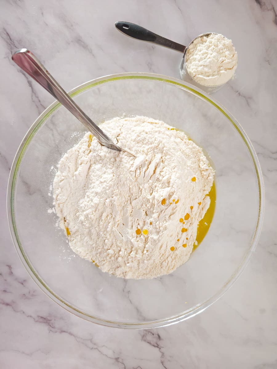 adding flour to oil for dough