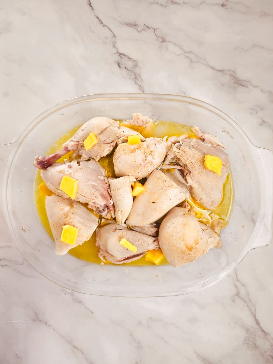 boiled chicken in a baking dish with butter