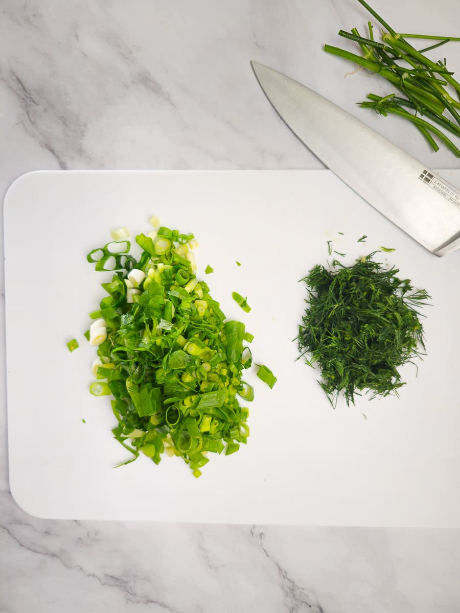 chopping spring onions and dill