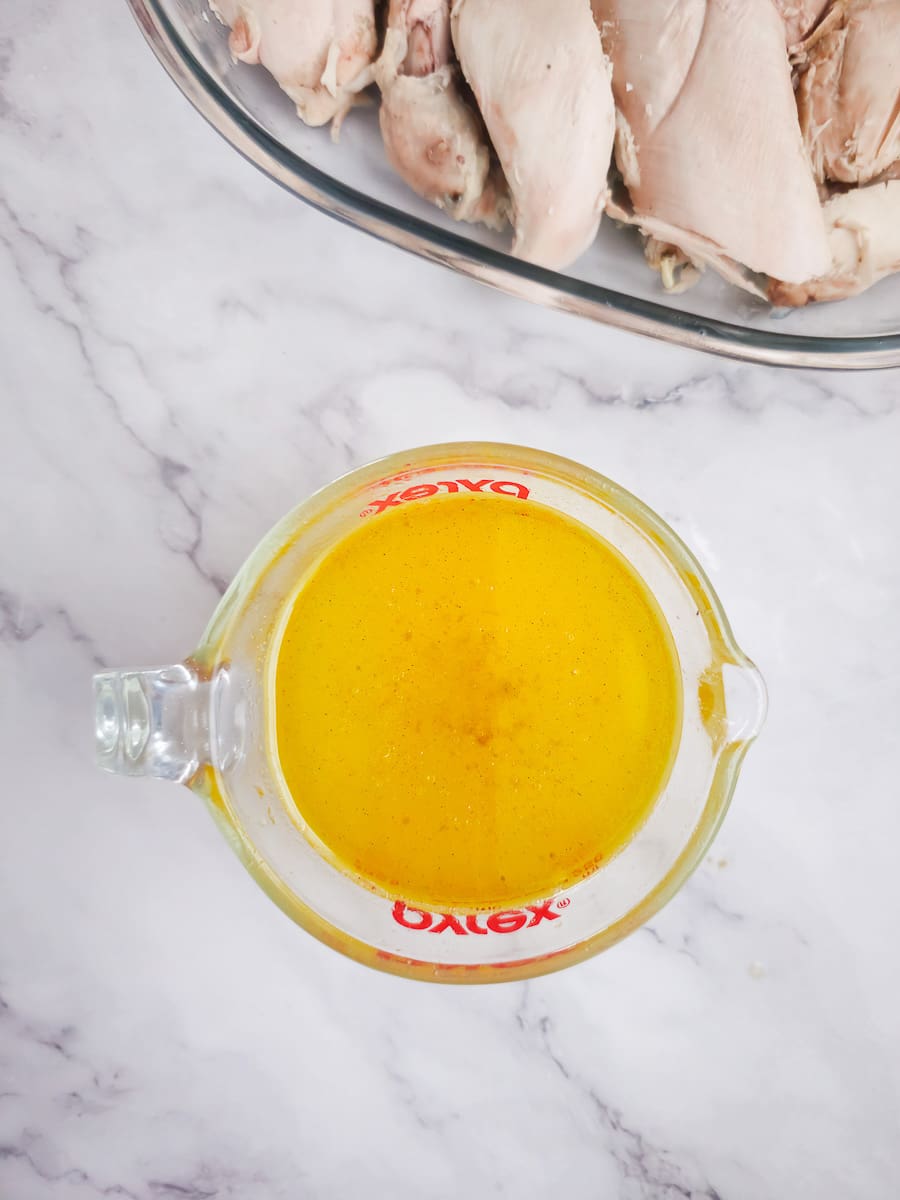 lemon and olive oil in a measuring jug for baked chicken