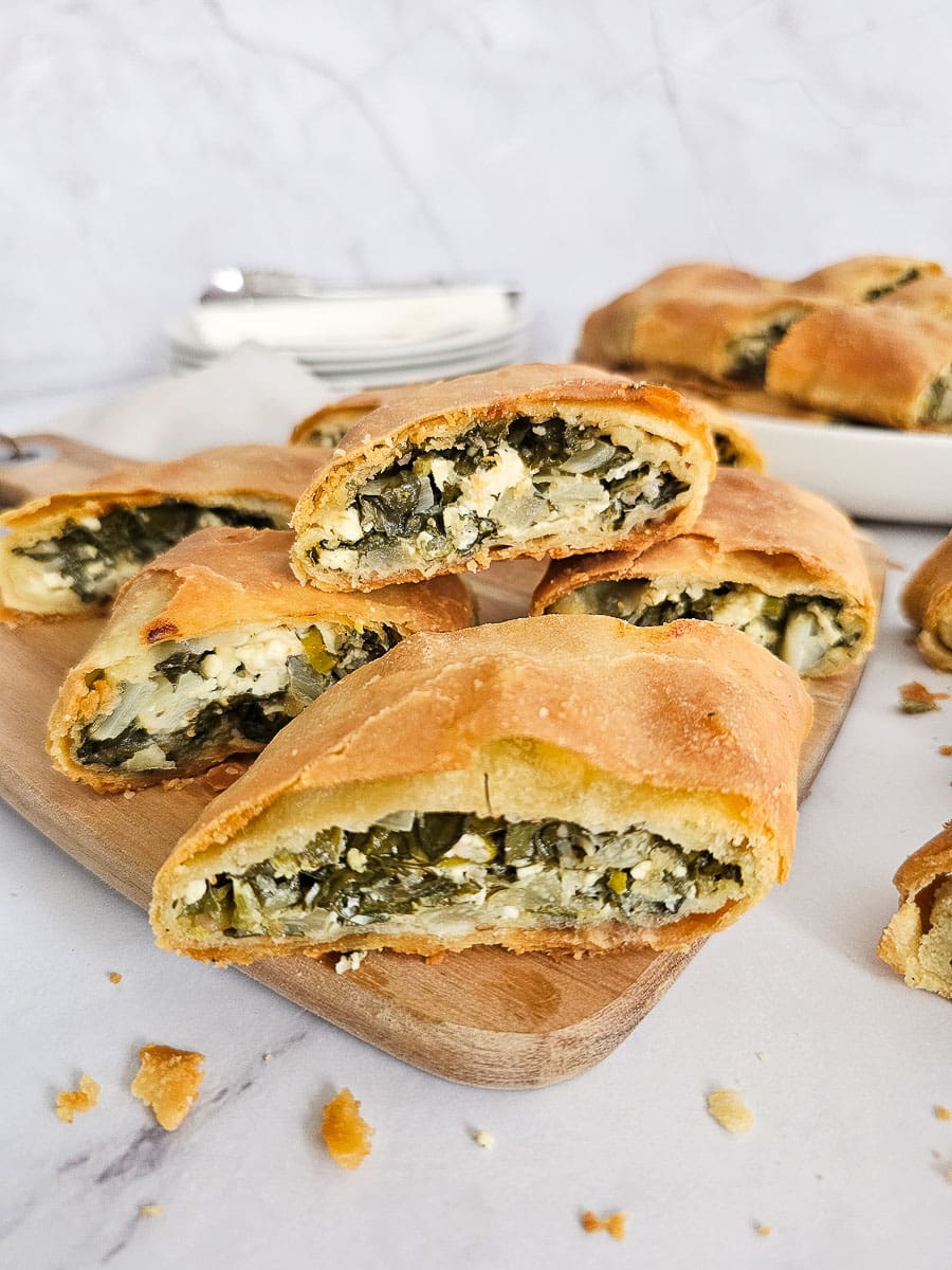 spanakopita on a chopping board ready to serve