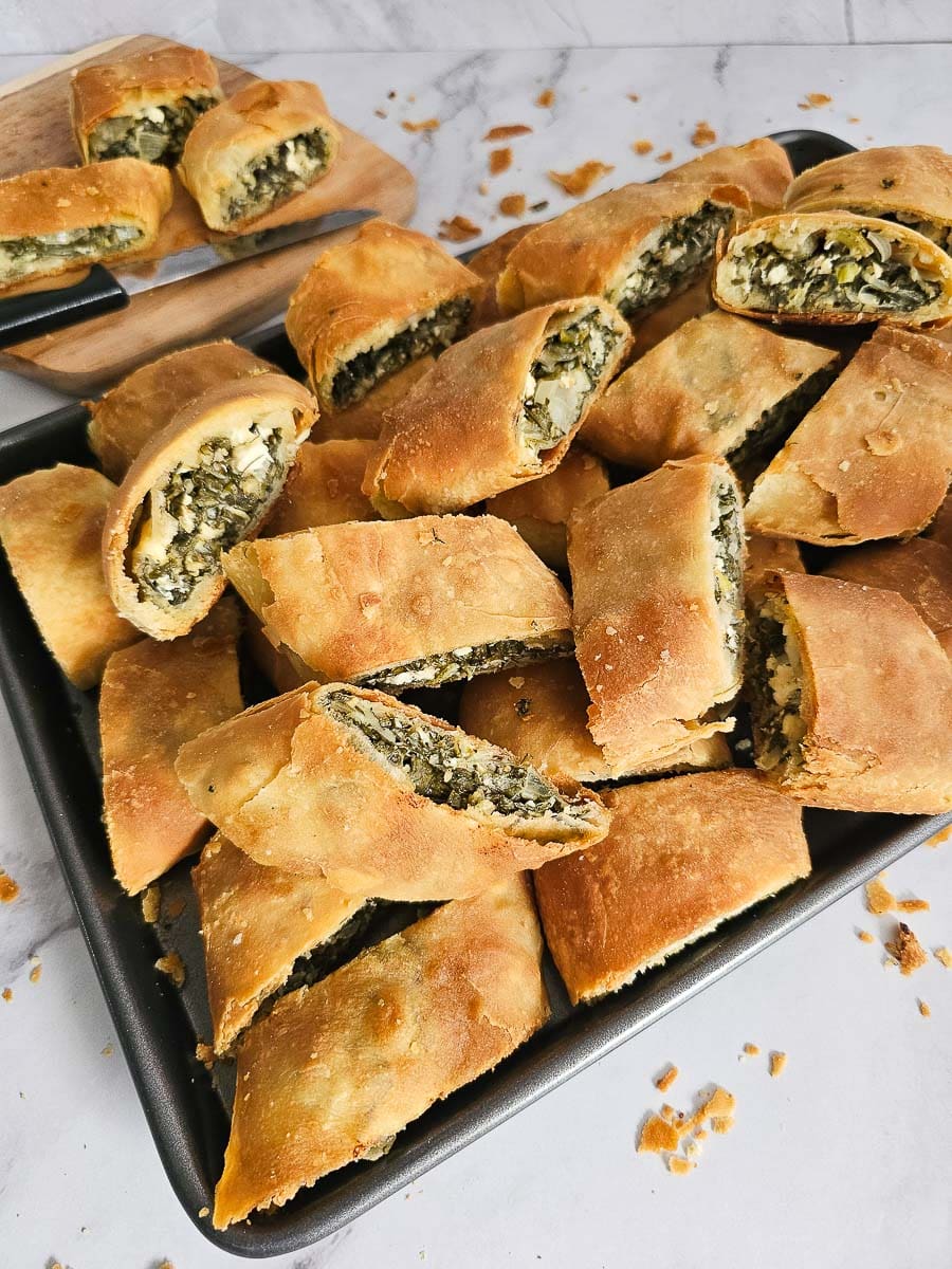 spanakopita pieces on a baking tray