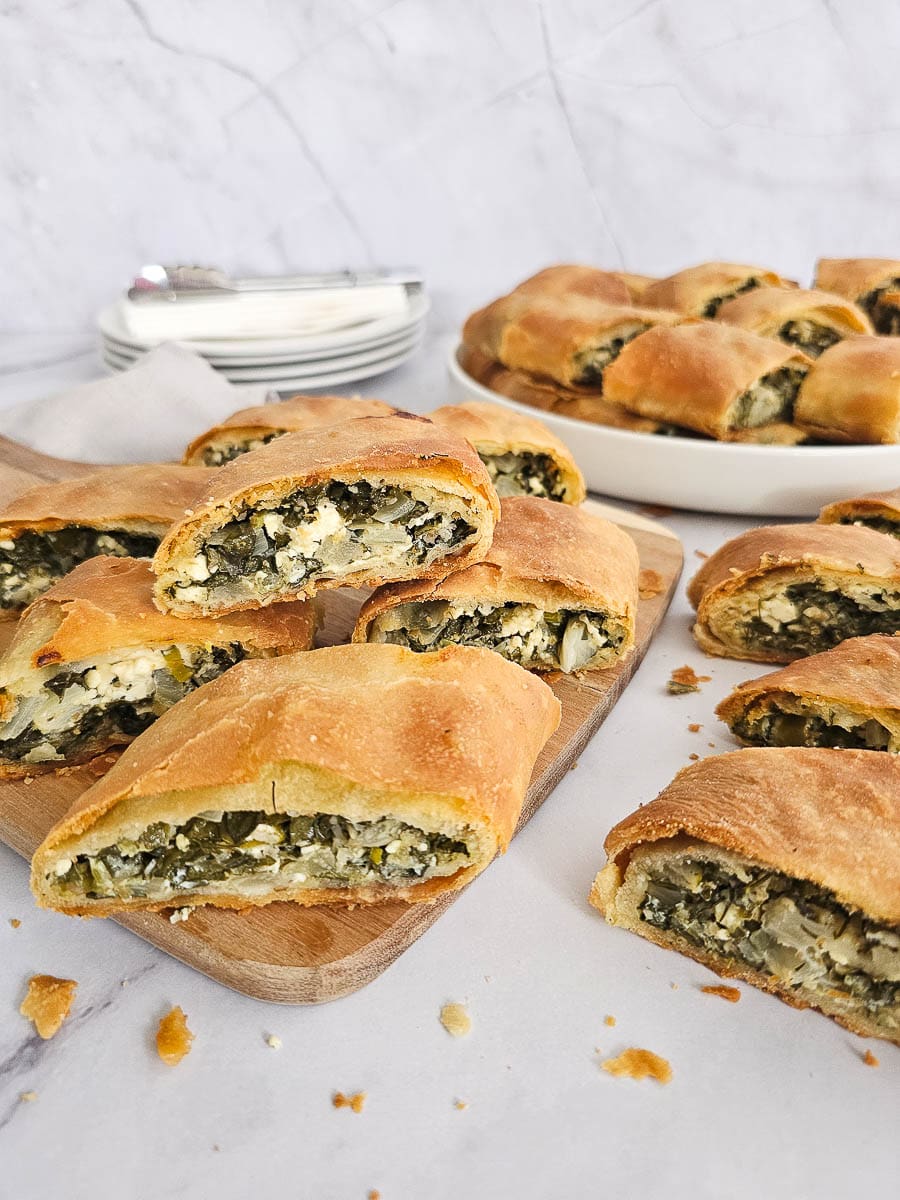 Greek Spinach and Feta Pie- Spanakopita on a chopping board ready to serve