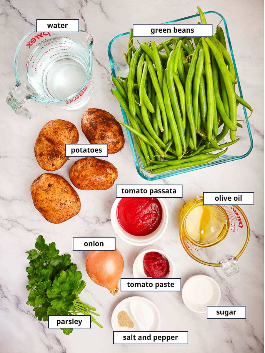 Fasolakia -Green Beans with potatoes on a plate - ingredients