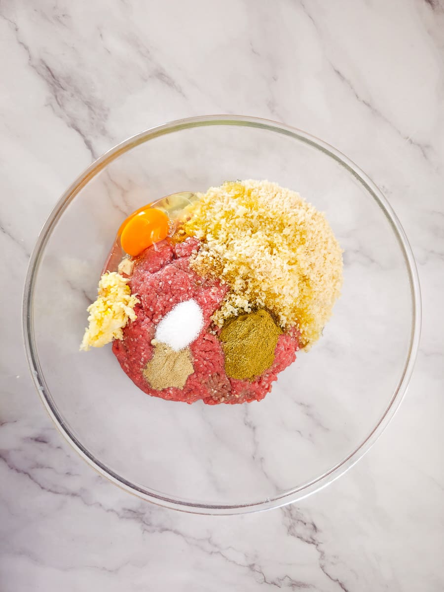 combining mince mixture in a bowl 