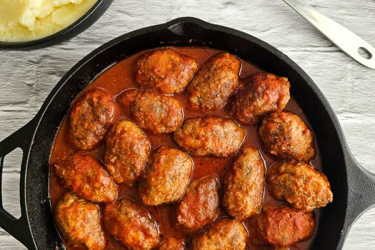 Soutzoukakia - Greek meatballs in tomato sauce in a saucepan