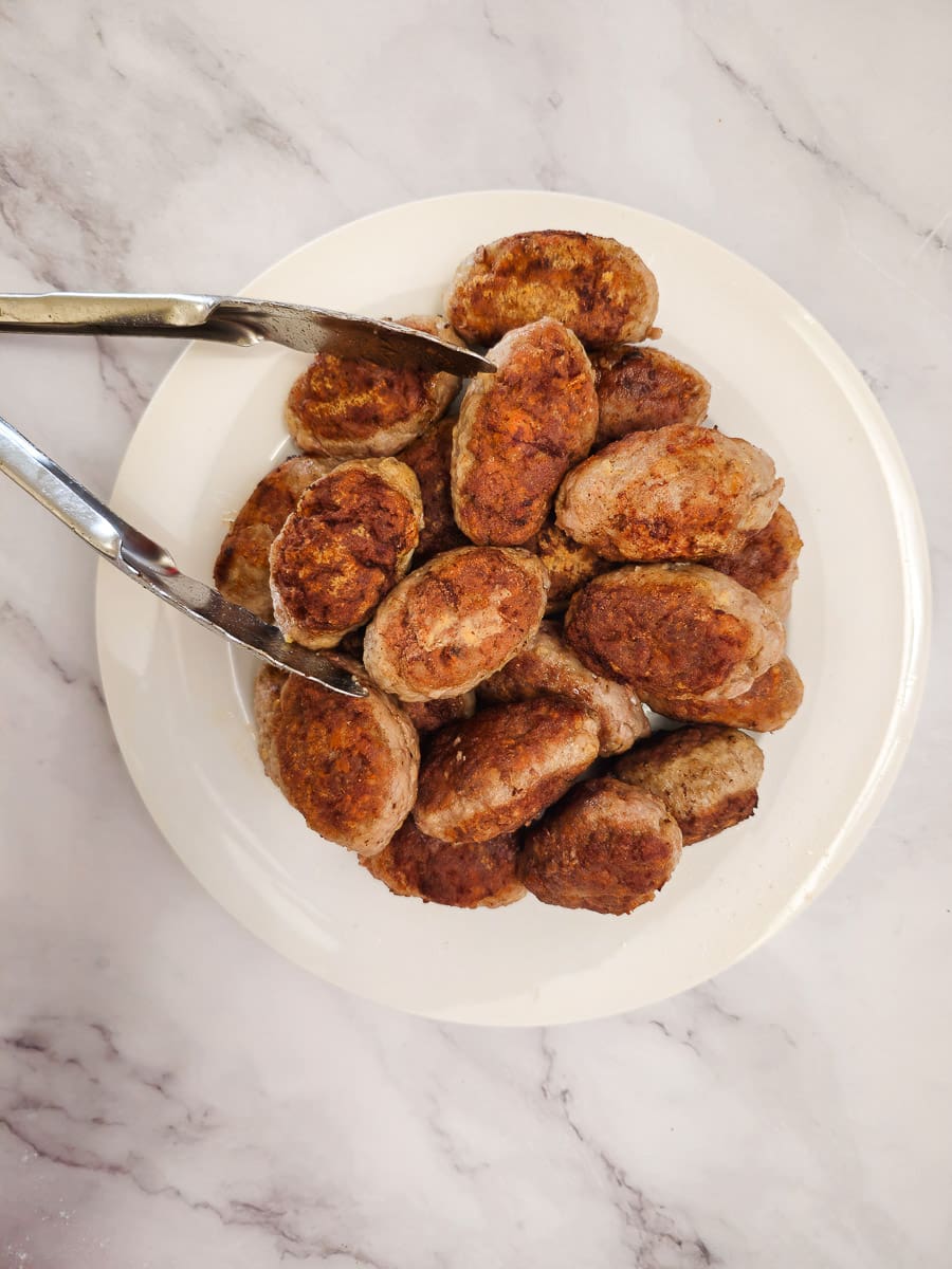 Soutzoukakia - Greek meatballs on a plate before adding to sauce