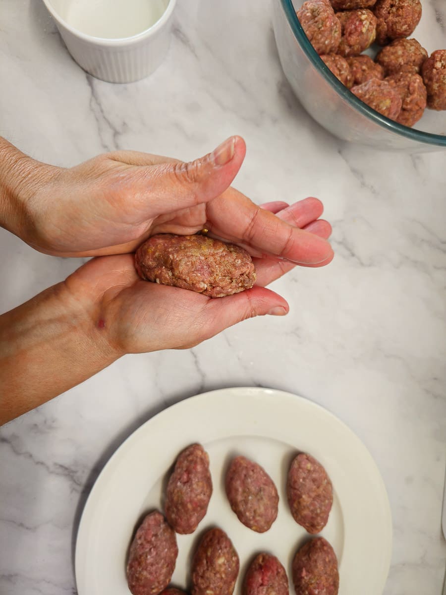 Shaping Soutzoukakia - Greek meatballs in hand