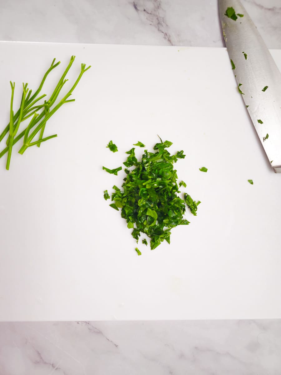 chopping parsley on board