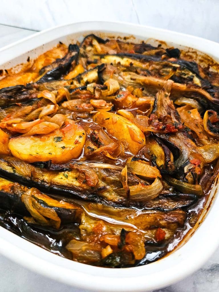 Eggplants, potaoes and tomatoes in a baking dish