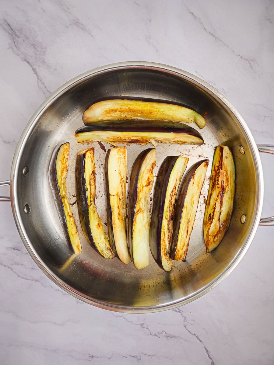 shallow frying eggplant in frying pan