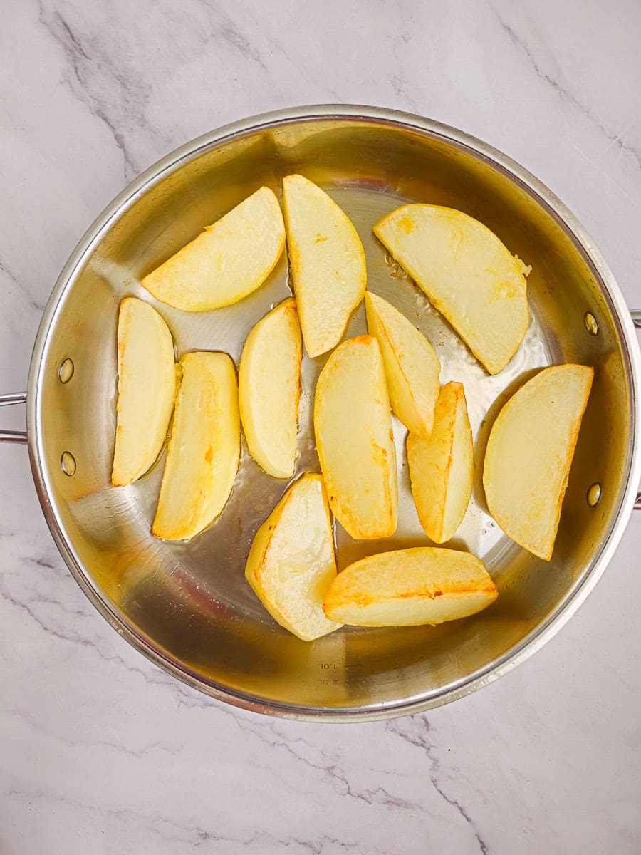 shallow frying potatoes in frying pan