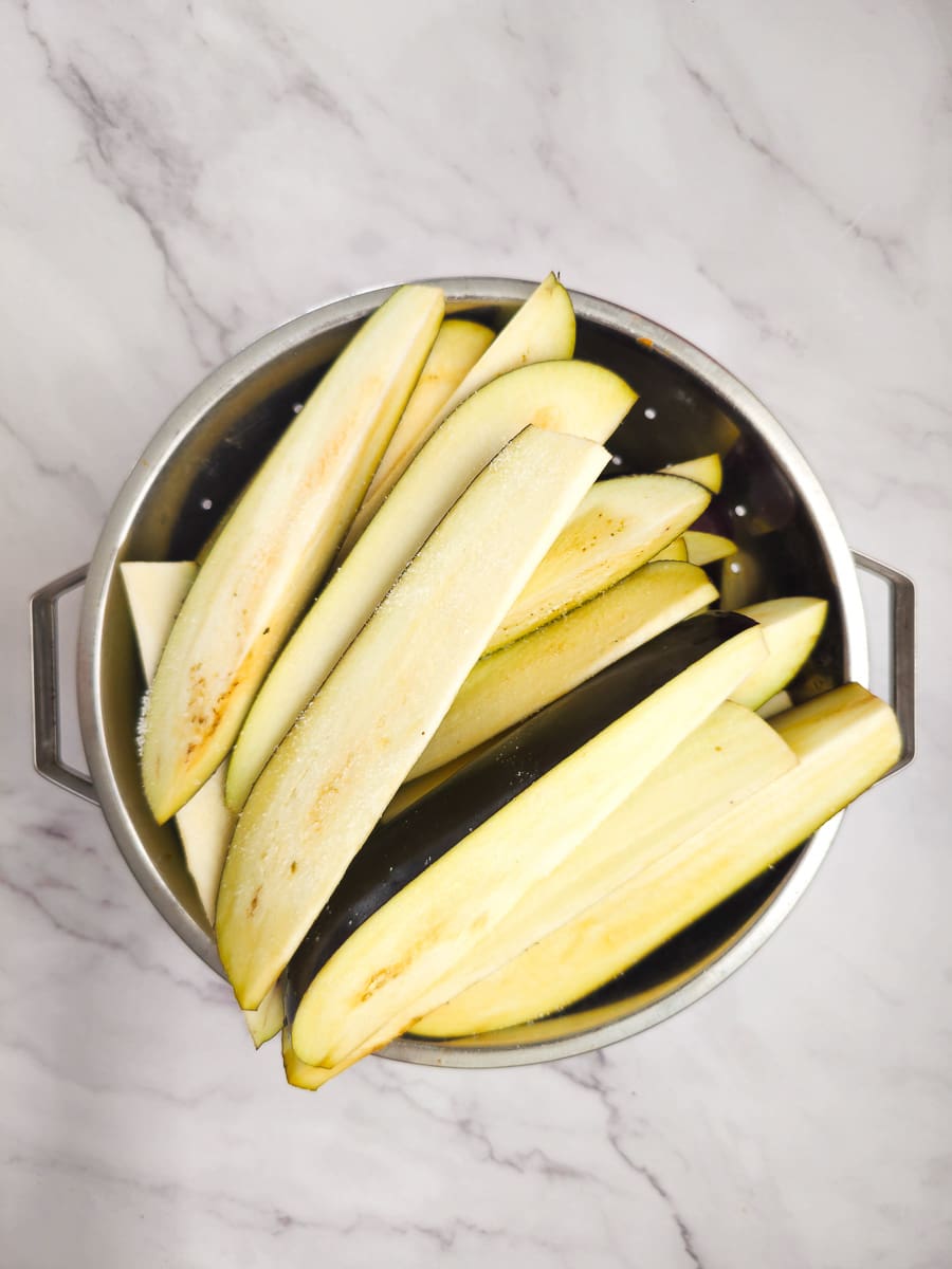 sliced eggplants in colander