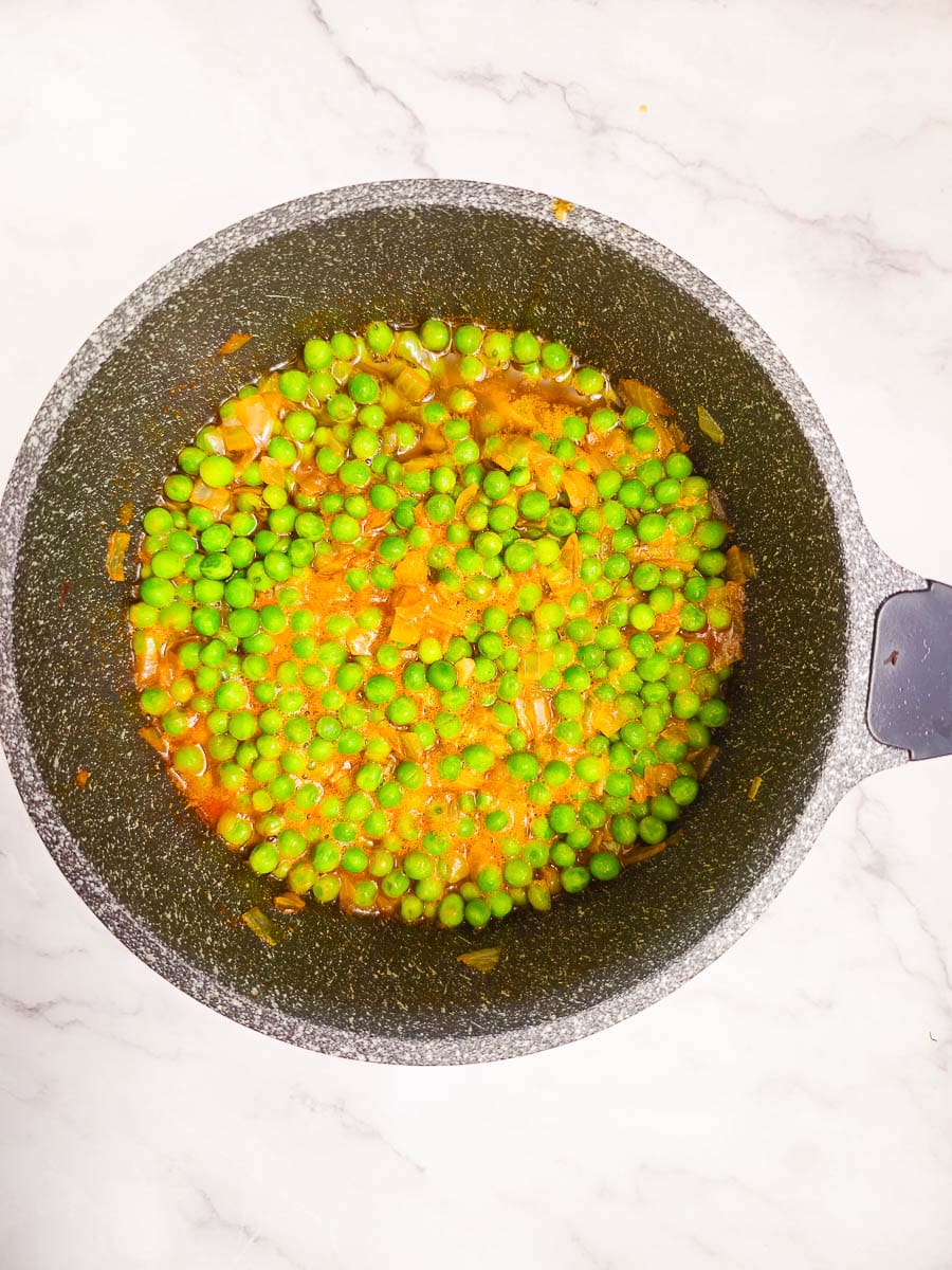 Greek Peas in Tomato Sauce Arakas Latheros simmering in a pot.