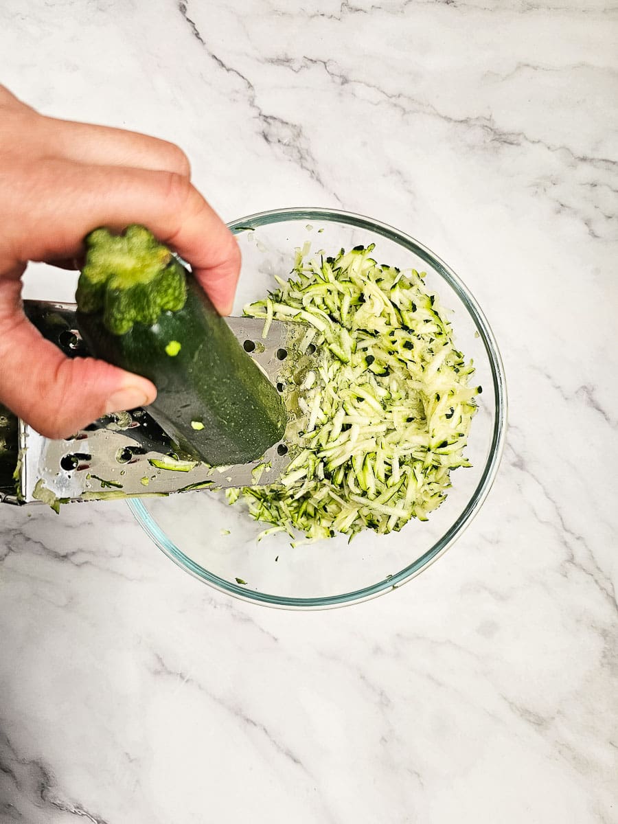 Grating zucchini in a bowl