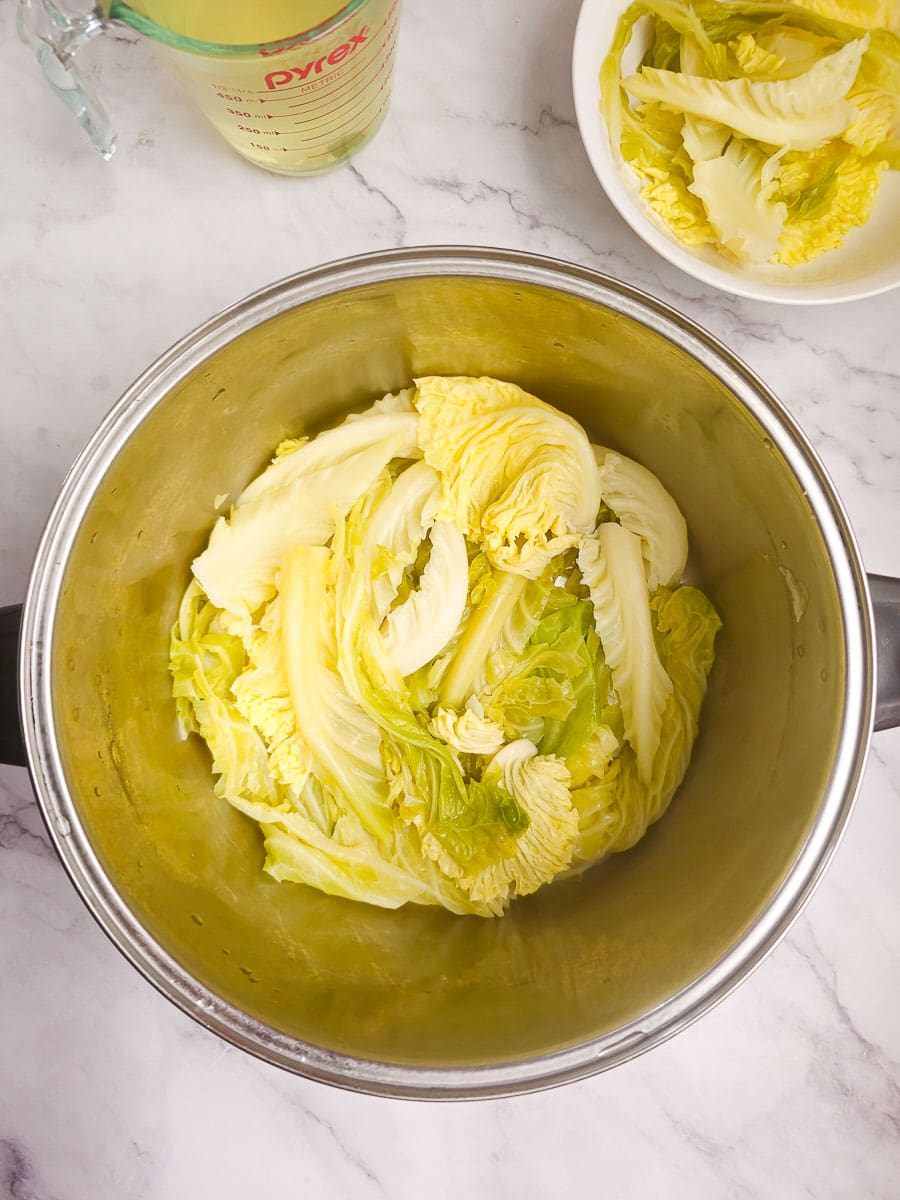 Lahanodolmades-Greek Stuffed Cabbage Rolls - lining pot with cabbage leaves