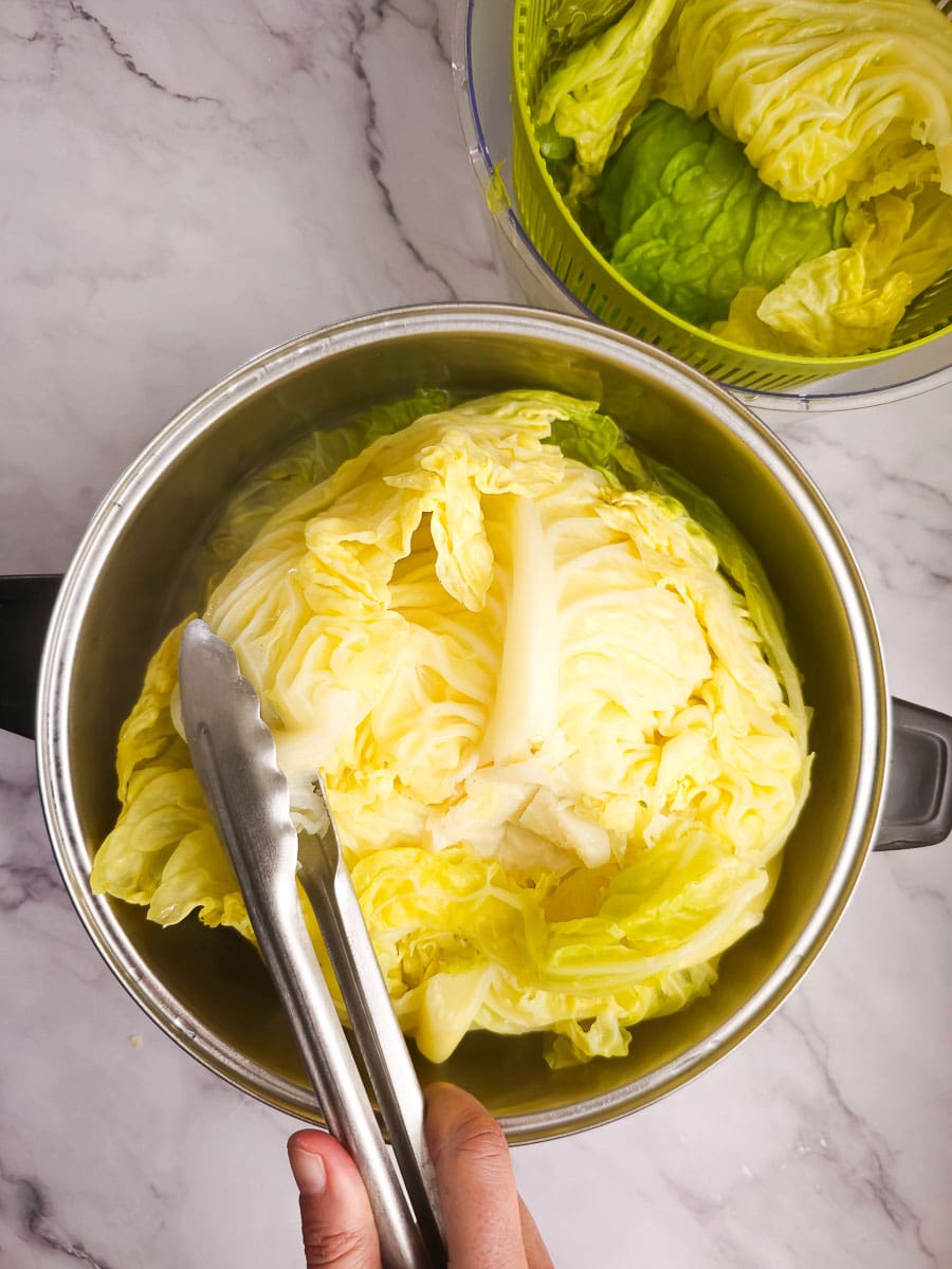 Lahanodolmades-Greek Stuffed Cabbage Rolls boiling cabbage in pot