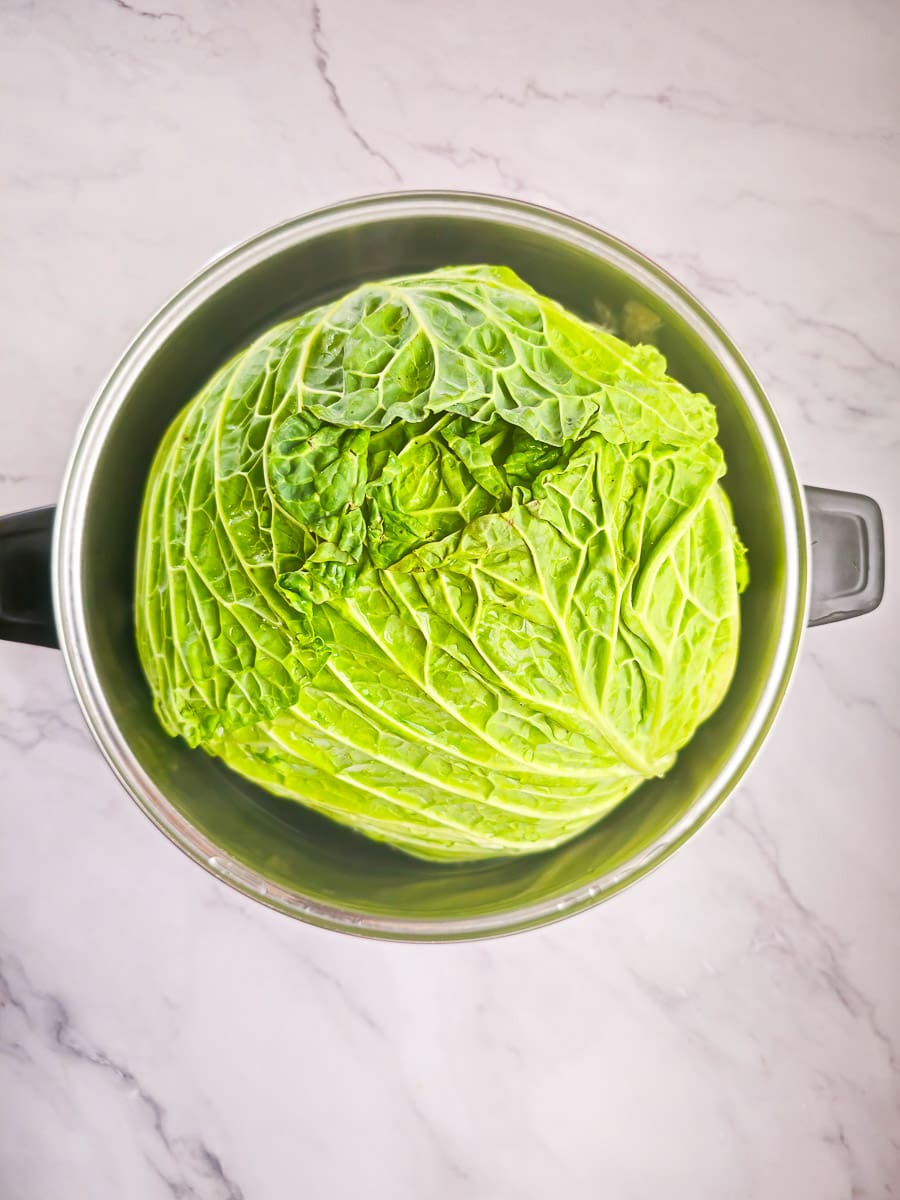 Lahanodolmades-Greek Stuffed Cabbage Rolls boiling cabbage in pot