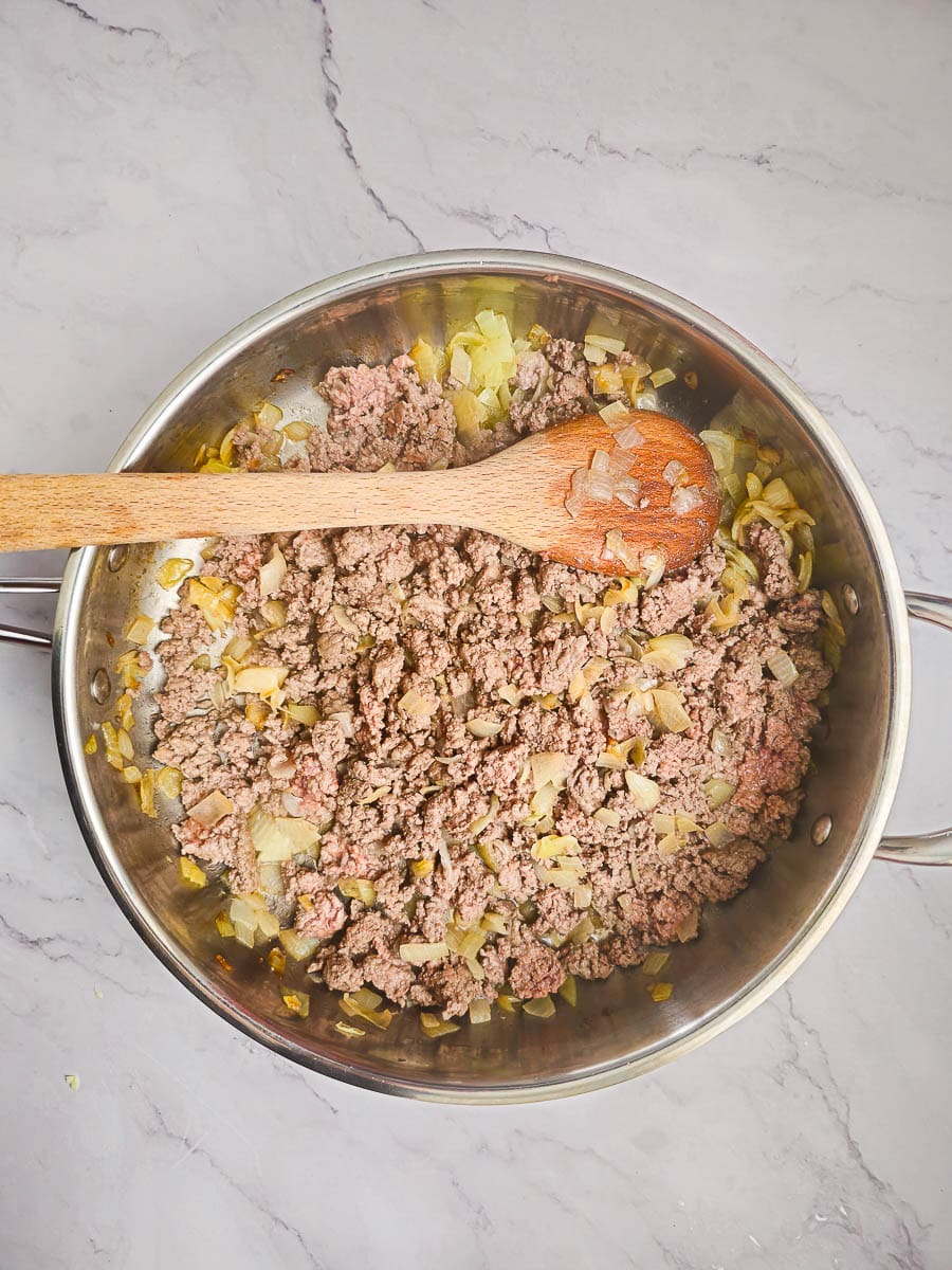 sauteing mince in frying pan with wooden spoon