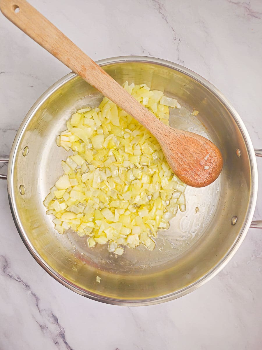 sauteeing onions in frying pan