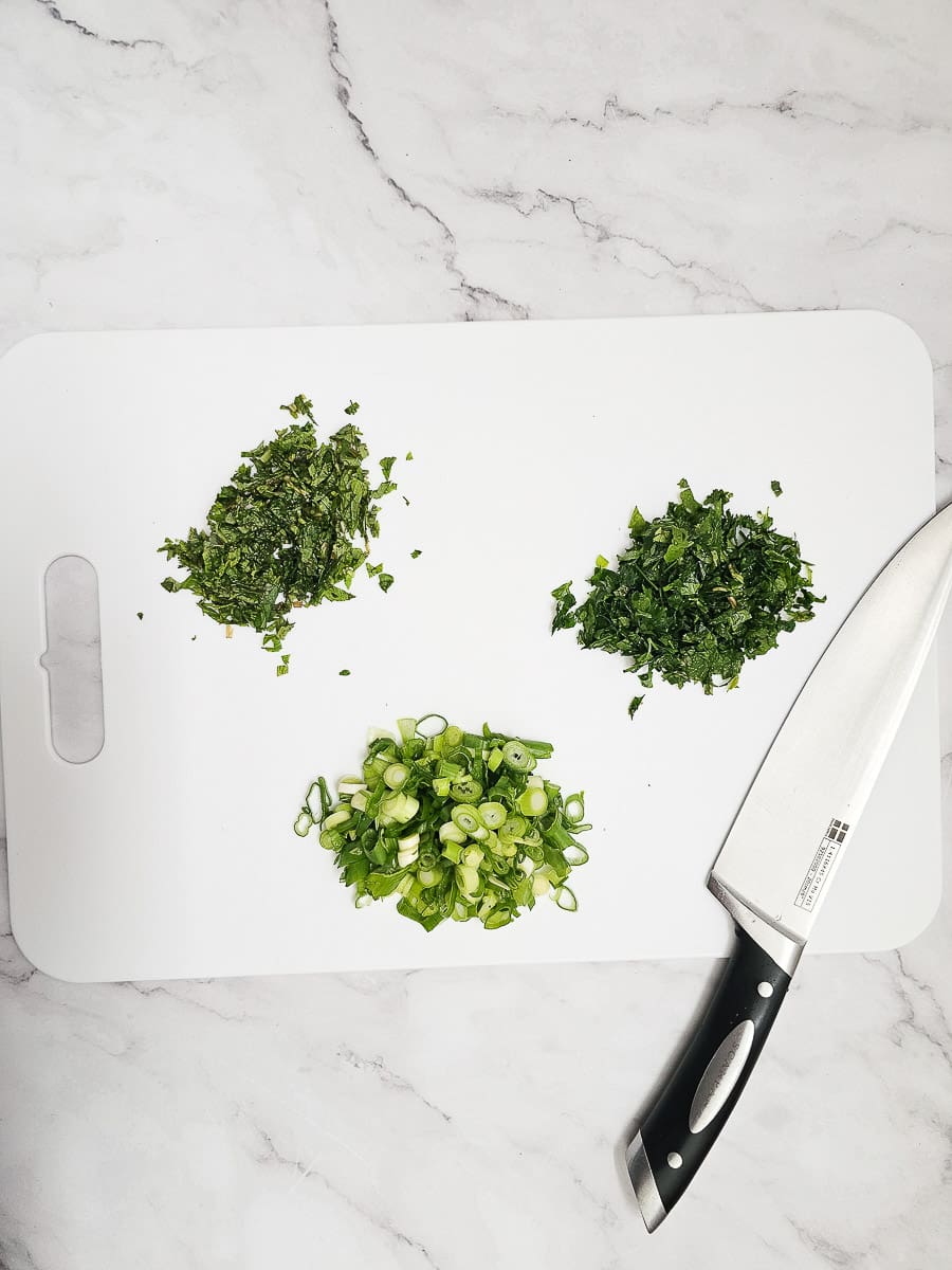 chopped herbs on board